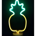 A glowing neon pineapple lamp led neon lights with green christmas tree colors creating perfect ambiance