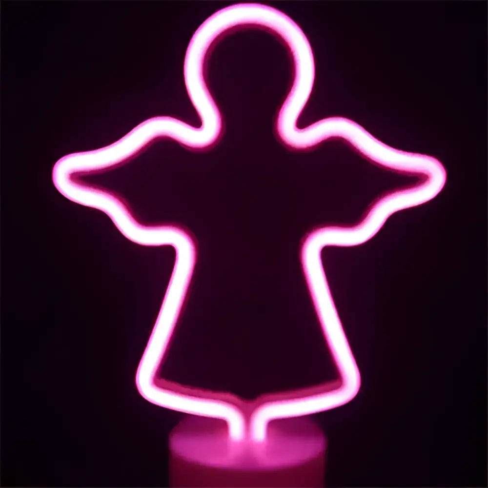 Pink neon angel-shaped led neon lights creating perfect ambiance for green christmas tree decoration with base
