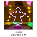 A glowing pink neon angel lamp with purple base paired with green christmas tree led neon lights for perfect ambiance