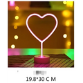 Pink neon heart-shaped led neon lights with glowing outline and circular base creating perfect ambiance