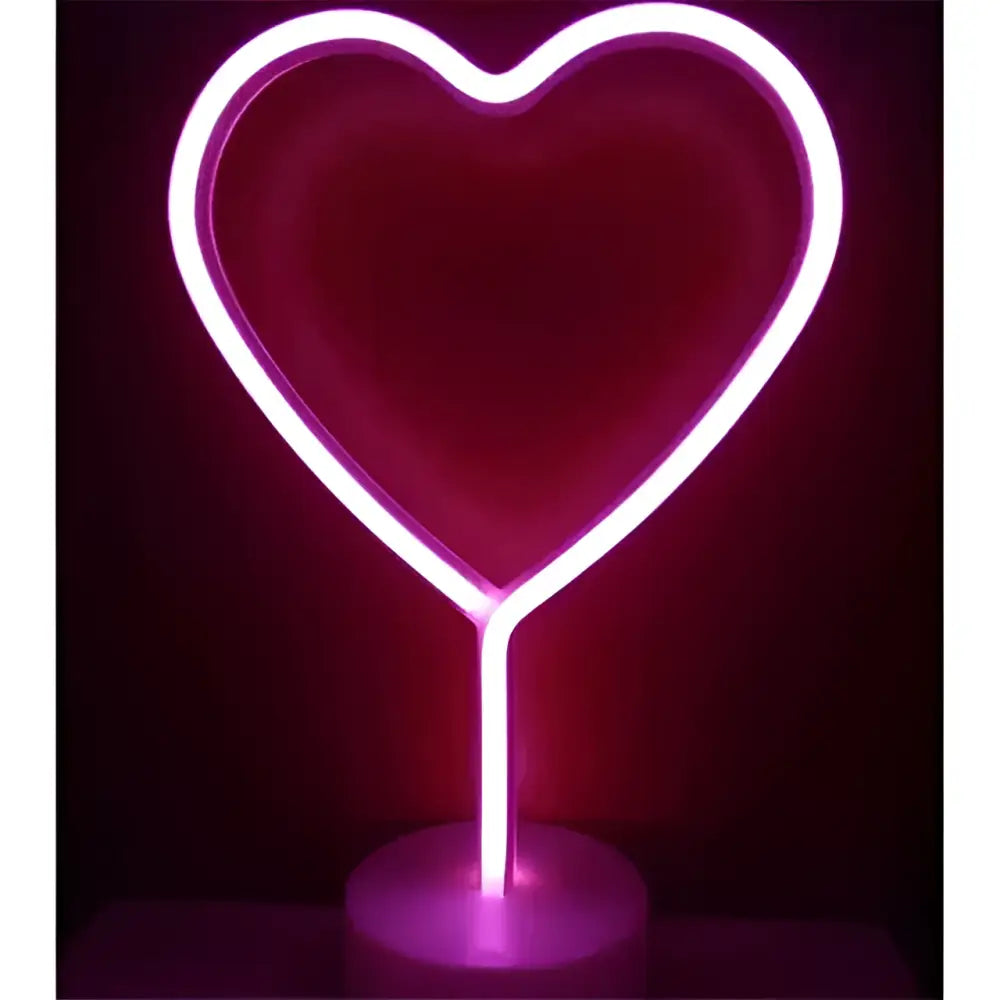 A glowing pink neon heart-shaped lamp with a cylindrical base offers perfect ambiance alongside green christmas tree led neon lights