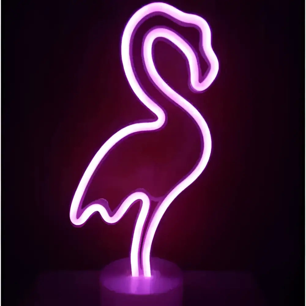 A glowing purple led neon lights sign shaped like a flamingo creating a perfect ambiance with green christmas tree decor