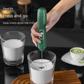 Green handheld battery version milk frother with sleek ergonomic design and silver accent button for frothing milk