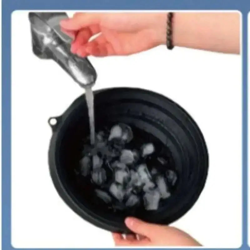 Black collapsible silicone ice basin being rinsed under running water featuring green honeycomb collapsible design