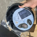 Black silicone ice basin with circular label showing face drawing highlighting benefits for green honeycomb collapsible use