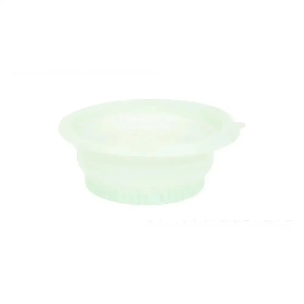Translucent light green silicone lid with small side tab for green honeycomb collapsible silicone ice basin