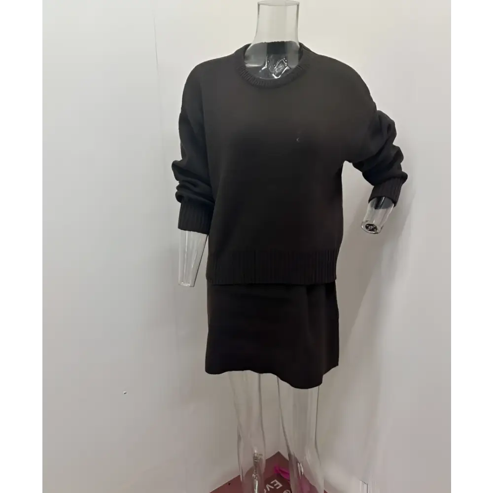 Black knit casual sweater dress with ribbed cuffs and hem displayed on mannequin in green long sleeve sweater skirt sets