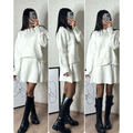 White oversized knit sweater dress with ribbed hem and cuffs paired with black combat boots in green long sleeve sweater skirt sets