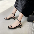 Black leather minimalist square toe block heel sandals with low kitten heel and ankle strap for elegant wear
