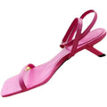 A vibrant pink satin sandal featuring a minimalist square toe and slender ankle strap with stiletto heel