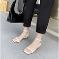 White minimalist square toe block heel sandals with ankle strap and thin stiletto heel in a sleek design