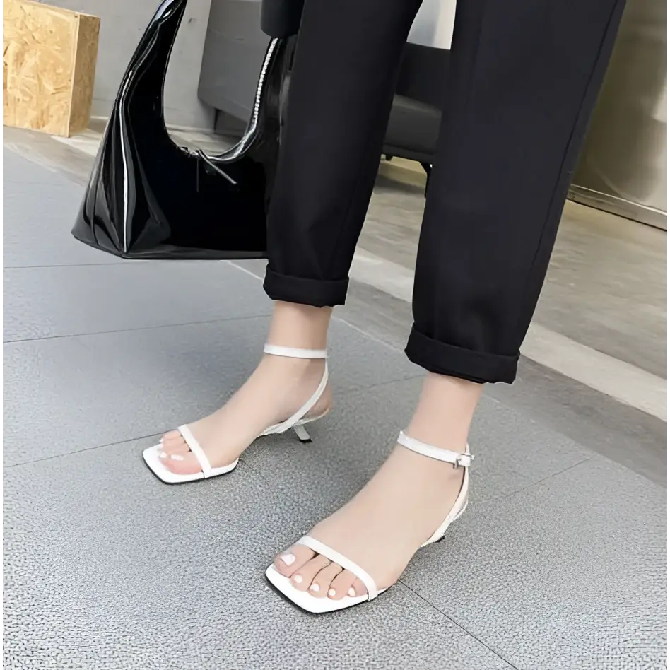 White minimalist square toe block heel sandals with ankle strap and thin stiletto heel in a sleek design