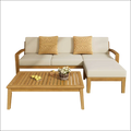 Beige grenada l shape sofa set with acacia wood frame and two mustard-yellow knitted throw pillows for outdoor use