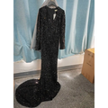 Black long sleeve sequin mermaid evening dress with v-neckline and flowing train in floor-length gown style