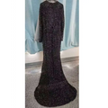 Grey long sleeve sequin mermaid evening dress with a fitted silhouette, black sequins, and sheer sleeves