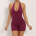 Halter neck high elastic yoga romper featuring a deep maroon form-fitting one-piece with v-cut neckline and short legs