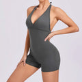 A sleek dark gray halter neck high yoga romper featuring a v-cut neckline and high-waisted shorts design
