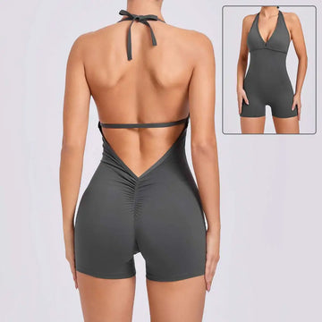 A sleek dark gray halter neck high yoga romper featuring a v-cut neckline back tie and ruched detailing