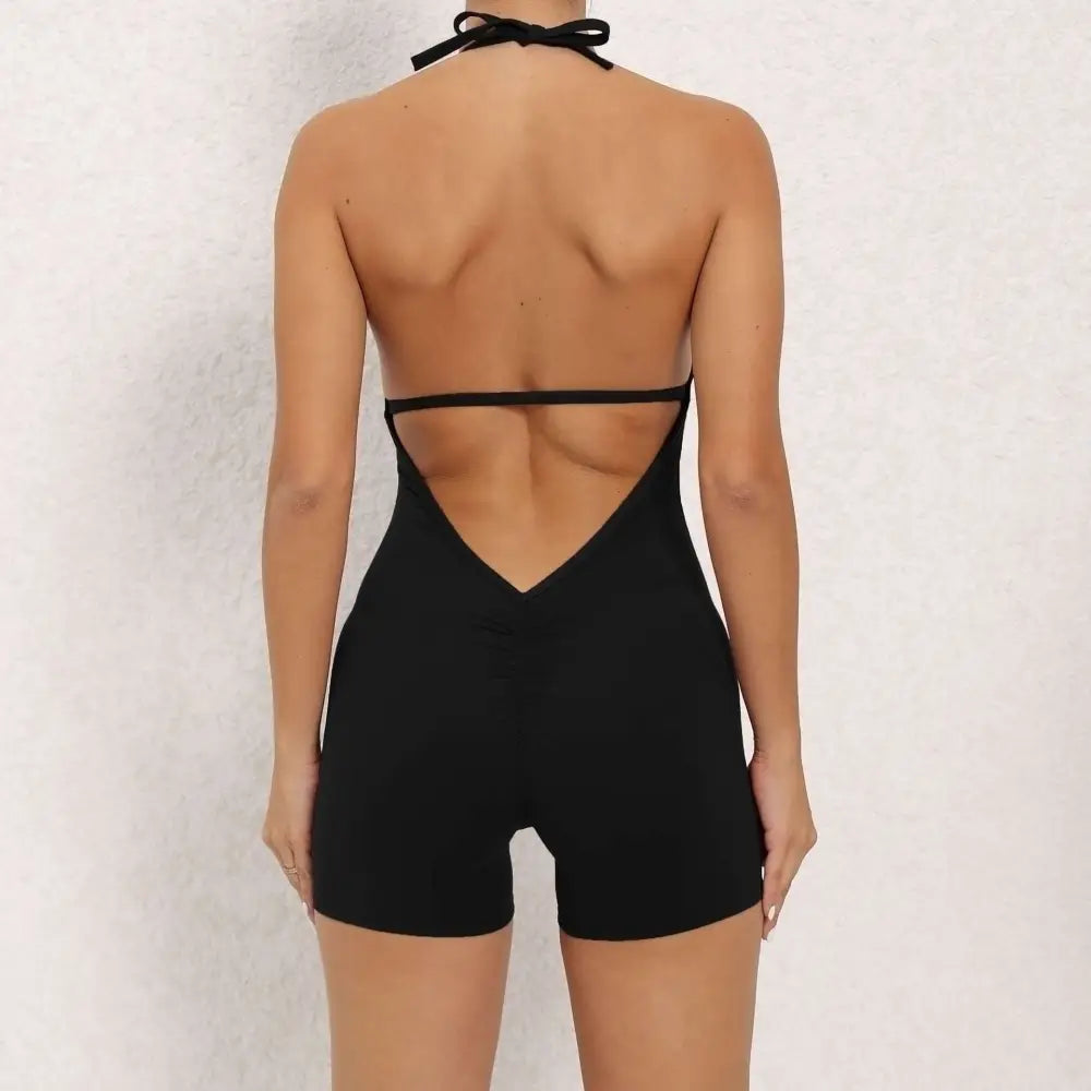 Black halter neck high elastic yoga romper featuring thin straps and a deep v-cut neckline back view
