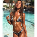 Hand-crocheted floral bikini in navy blue with white frayed trim and shell design featuring a tie-up front