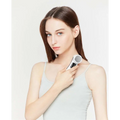 White and silver handheld digital iontophoresis personal care device with sleek modern design for negative iontophoresis therapy