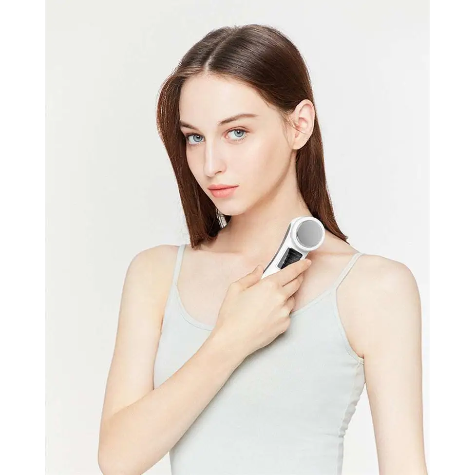 White and silver handheld digital iontophoresis personal care device with sleek modern design for negative iontophoresis therapy