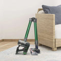 Green and gray handheld wireless vacuum with foldable tube designed for versatile cleaning and easy portability