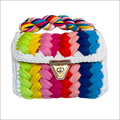 Handmade crocheted bag with colorful braided strap and multicolored fabric strips for wedding party events