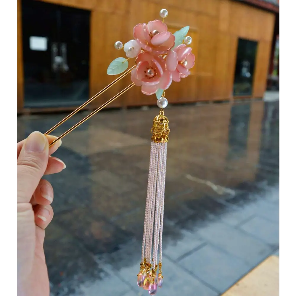 Handmade hanfu hairpin featuring a delicate pink floral design with pearls and a cascading pink floral tassel