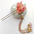 Handmade hanfu hairpin featuring an elegant delicate pink floral design with pearls and a pink floral tassel