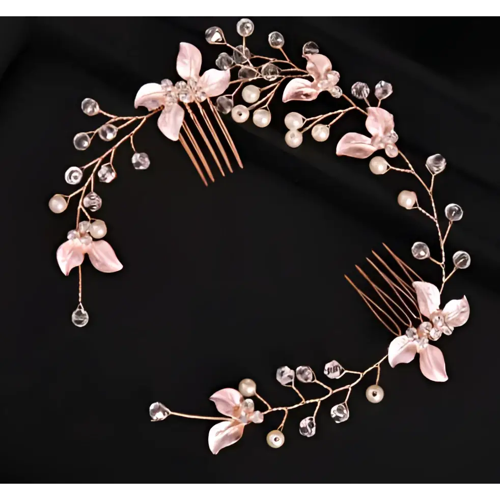 A delicate handmade leaf twisted rose gold hair comb with pink floral embellishments pearls and clear crystals