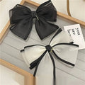 Elegant black and white handmade mesh bow hair clips with sheer fabric and a sleek minimalist design for women