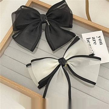 Elegant black and white handmade mesh bow hair clips with sheer fabric and a sleek minimalist design for women