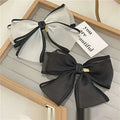 Elegant handmade mesh bow hair clips in black and white sheer fabric with gold-tone metal clasps for women