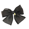 Handmade mesh bow hair clip in black sheer fabric with a small gold-colored tag at the center for women
