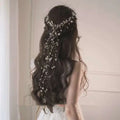Back view of a delicate silver beaded hair pearl fairy bridal headdress with pearls and crystals on dark hair