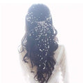Delicate handmade pearl fairy bridal beaded hair accessory with silver wire and cascading white pearls on dark hair backside