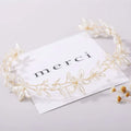 Elegant gold-toned handmade pearl twisted floral headpiece with delicate white pearls and intricate leaf designs
