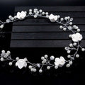 Handmade pearl white floral wedding hair chain featuring elegant white flowers with pearls and crystal accents on silver wire