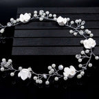 Handmade pearl white floral wedding hair chain featuring elegant white flowers with pearls and crystal accents on silver wire