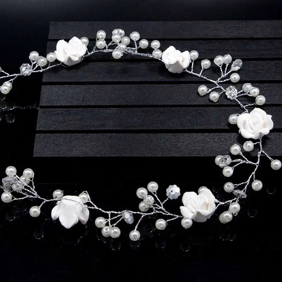 Handmade pearl white floral wedding hair chain featuring elegant white flowers with pearls and crystal accents on silver wire