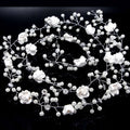 Handmade pearl white floral wedding hair chain with delicate pearls and clear crystals on a silver wire base