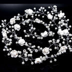 Handmade pearl white floral wedding hair chain with delicate pearls and clear crystals on a silver wire base