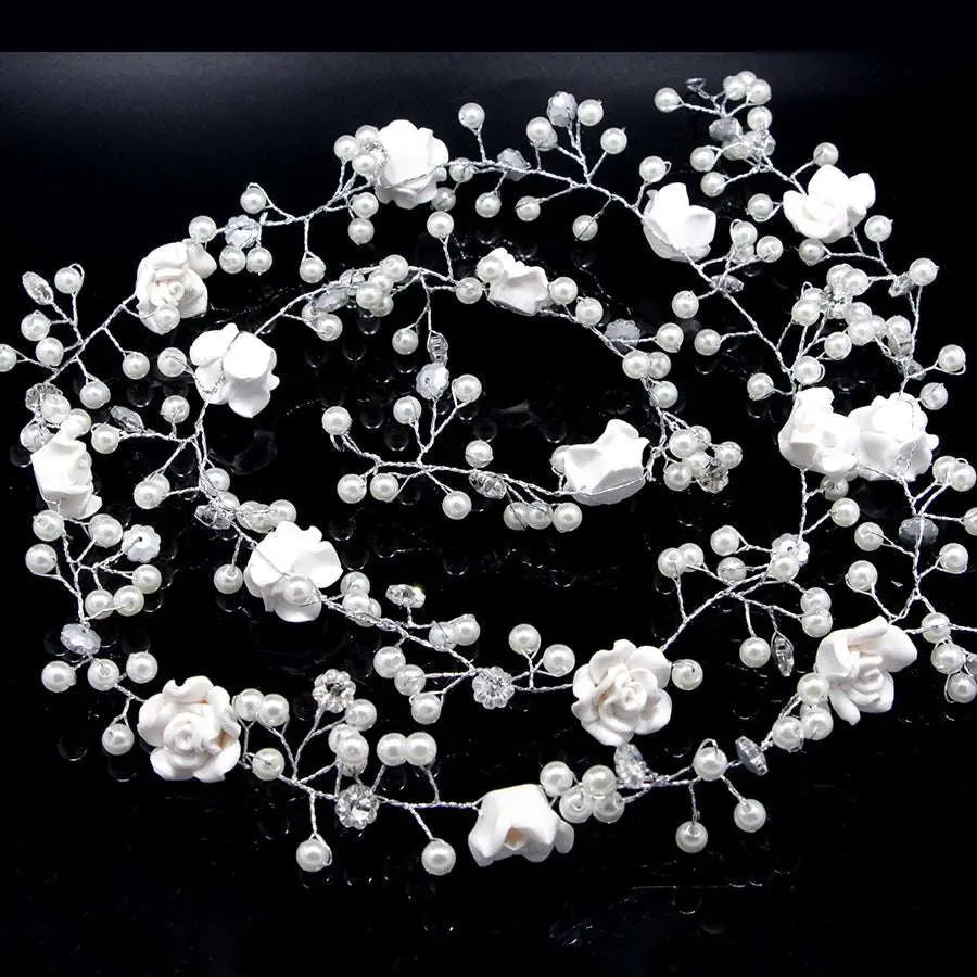 Handmade pearl white floral wedding hair chain with delicate pearls and clear crystals on a silver wire base
