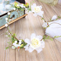 Elegant handmade white rose bridal veil with ivory and white floral wreath adorned with greenery and pearl beads