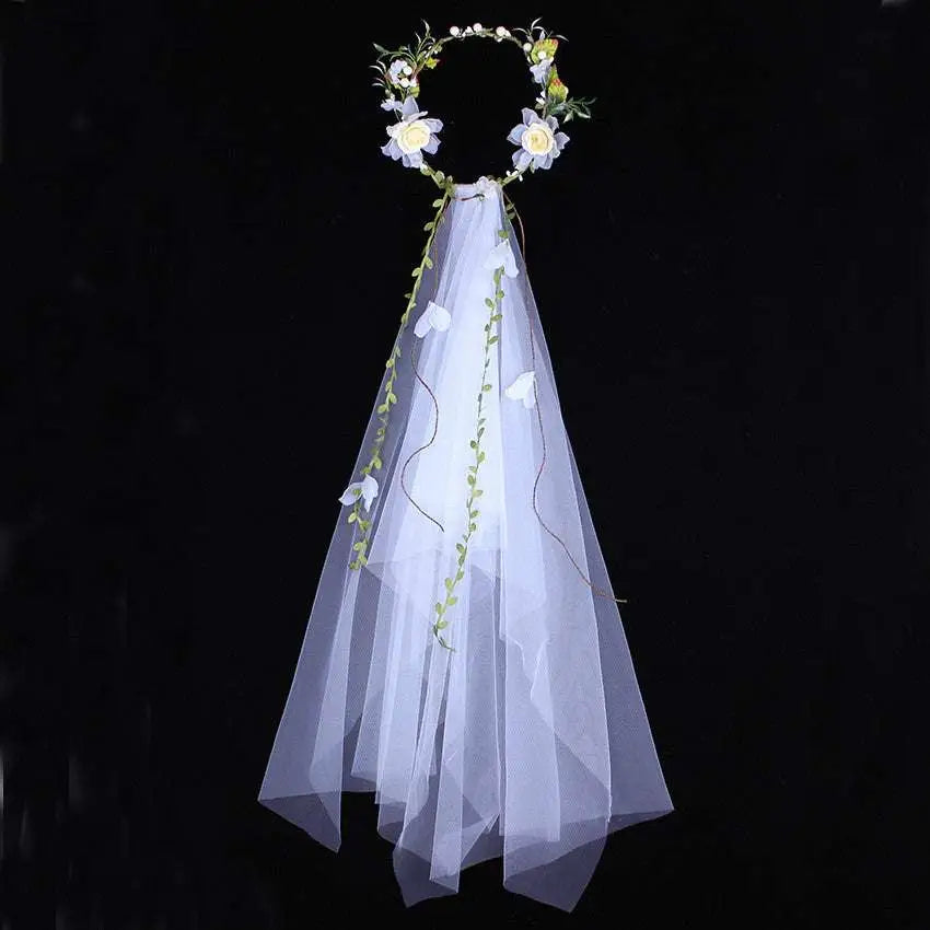 Handmade white rose bridal veil with delicate floral wreath featuring white flowers embroidered with green vines and sheer veil