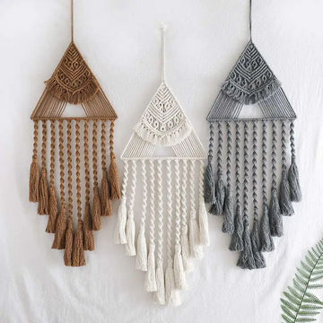Three handwoven home decor triangle dream catcher tassels in earthy brown white and gray with intricate woven patterns