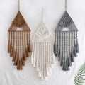 Three handwoven home decor triangle dream catcher tassels in earthy brown white and gray with intricate woven patterns