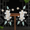 Elegant white floral bride Chinese luxury hairpins adorned with pearls and light blue jade leaves with matching drop earrings