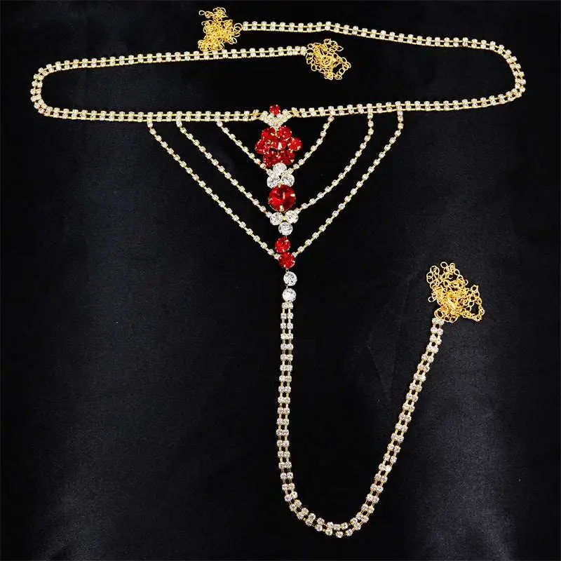 Gold-toned rhinestone panty body jewelry with central floral design in red and clear crystals and matching garter belt